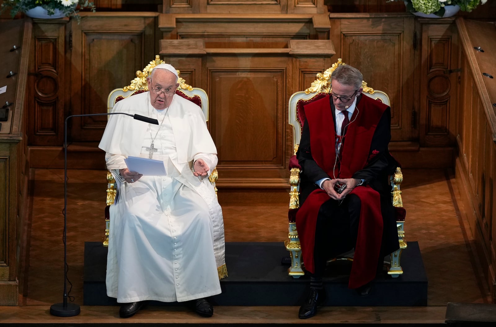 Pope Francis, left, flanked by Rector Luc Sels, delivers his speech during his meeting with the professors in the Promotiezaal of the Catholic University of Leuven, Belgium, Friday, Sept. 27, 2024. (AP Photo/Andrew Medichini)