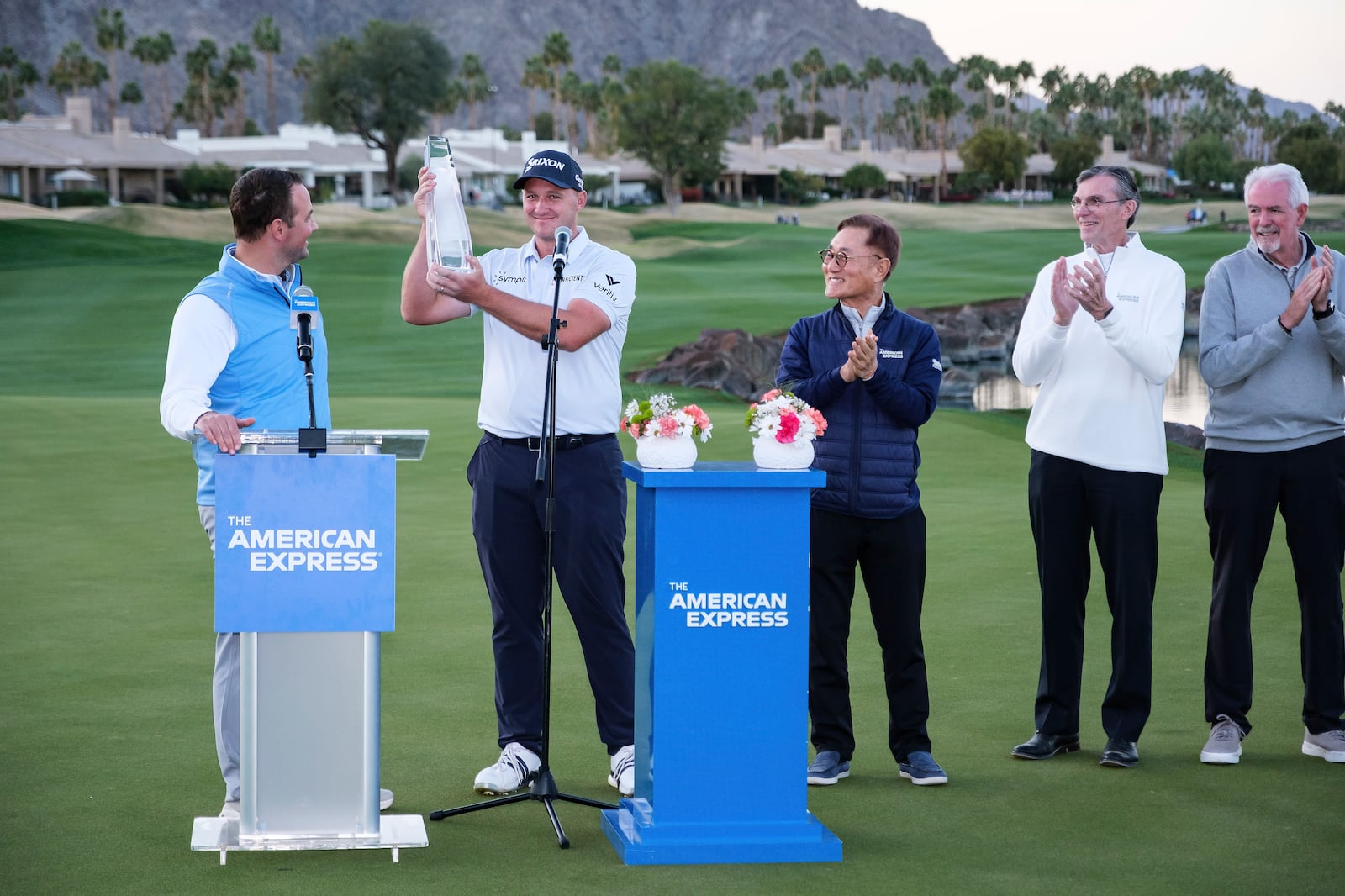 Sepp Straka, second from left, holds the trophy after winning the American Express golf tournament in La Quinta, Calif., Sunday, Jan. 19, 2025. (AP Photo/William Liang)