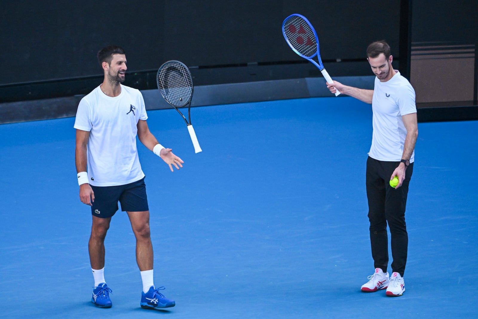 Novak Djokovic of Serbia, left, and coach Andy Murray react during a training session ahead of the Australian Open tennis tournament at Melbourne Park in Melbourne, Tuesday, Jan. 7, 2025. (James Ross/AAP Image via AP)