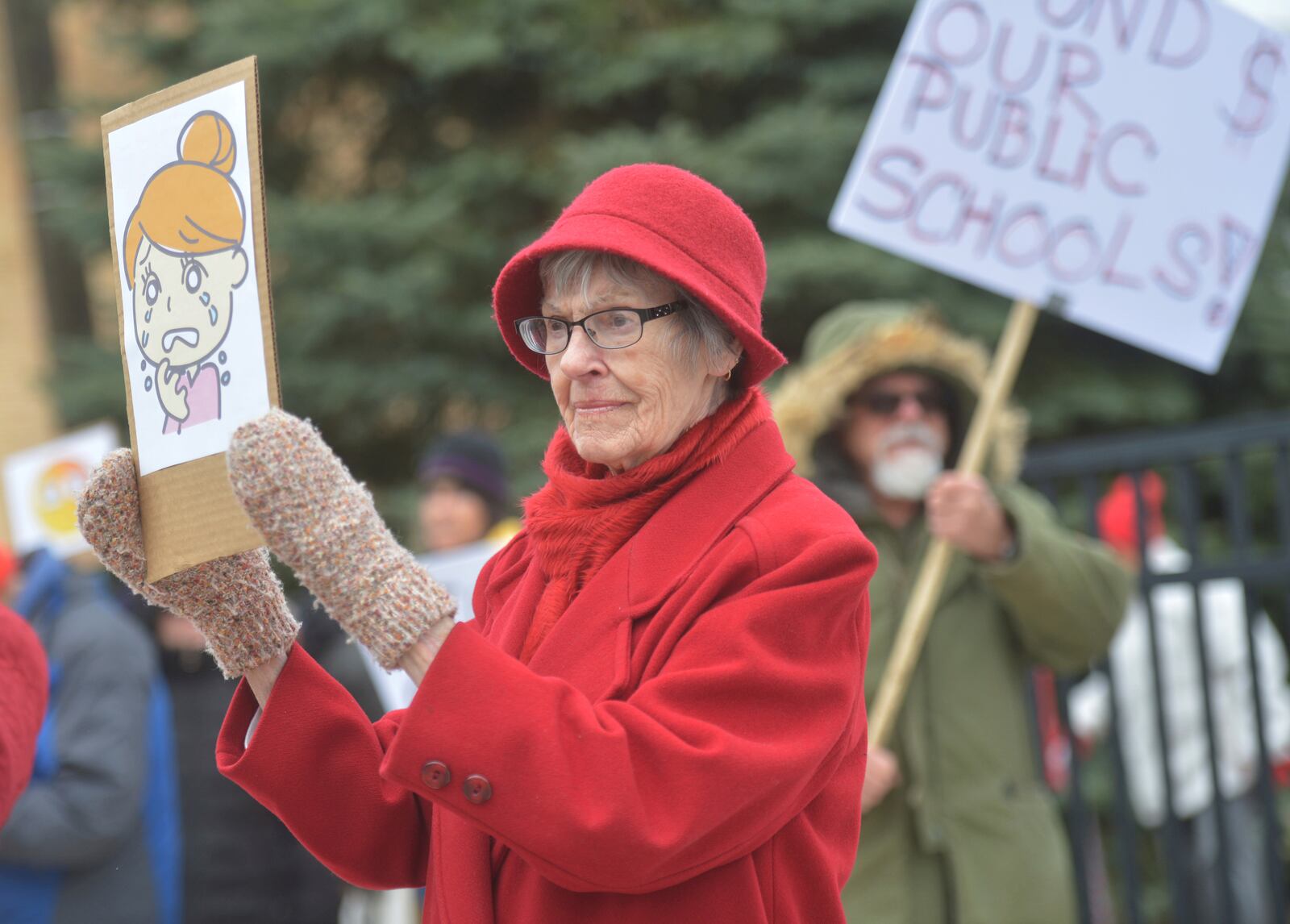 Cindy Mugent joins dozens of people gathered in downtown Niles, Mich., Thursday, March 20, 2025, to protest recent government cuts in the Department of Education. (Don Campbell/The Herald-Palladium via AP)