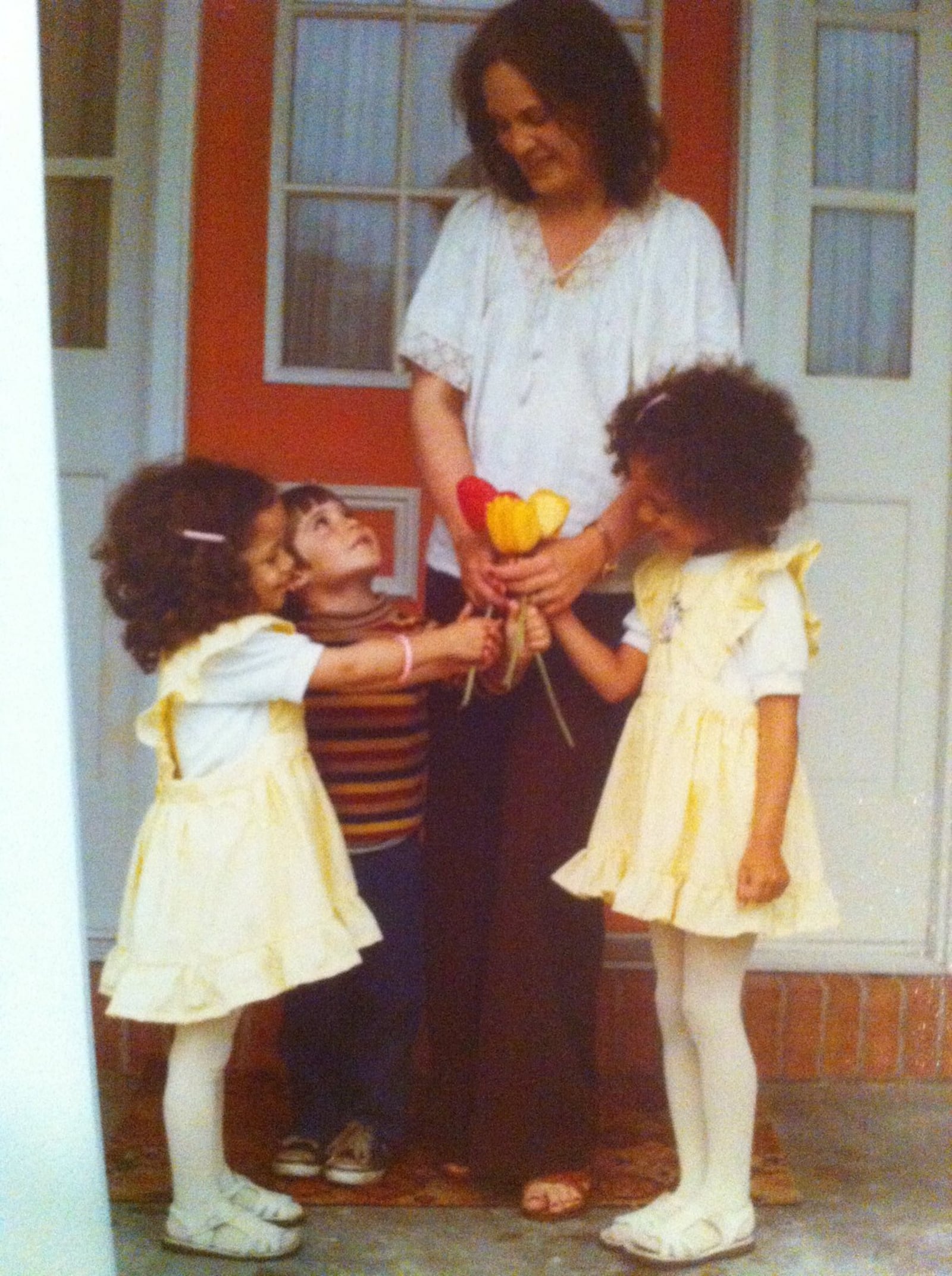 Lois Saum accepts tulips on Easter from her daughters Sherri (on the left) and Lisa. Their cousin, Brian, is also in the photo.