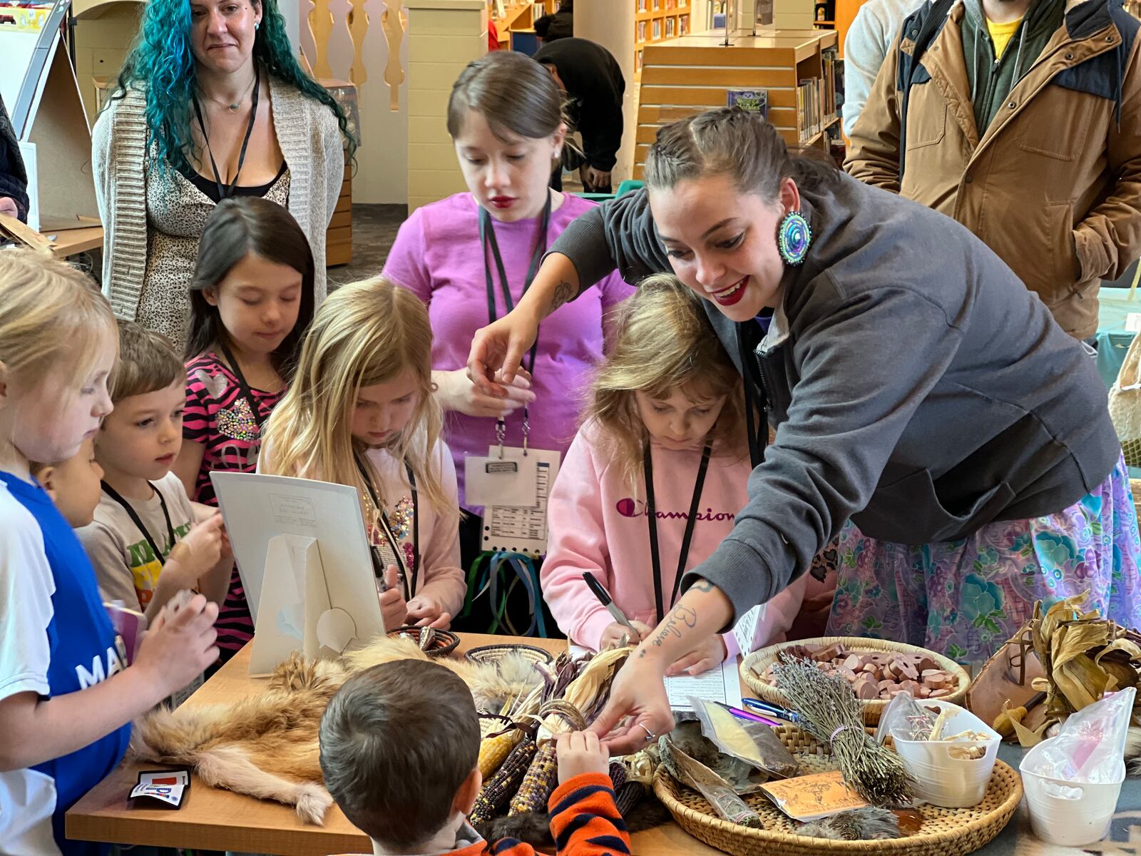 Lydia Green-Miller facilitates an activity at the Medicine Table during Saturday's REACH Fest held at the downtown Dayton Metro Library. AIMEE HANCOCK/STAFF