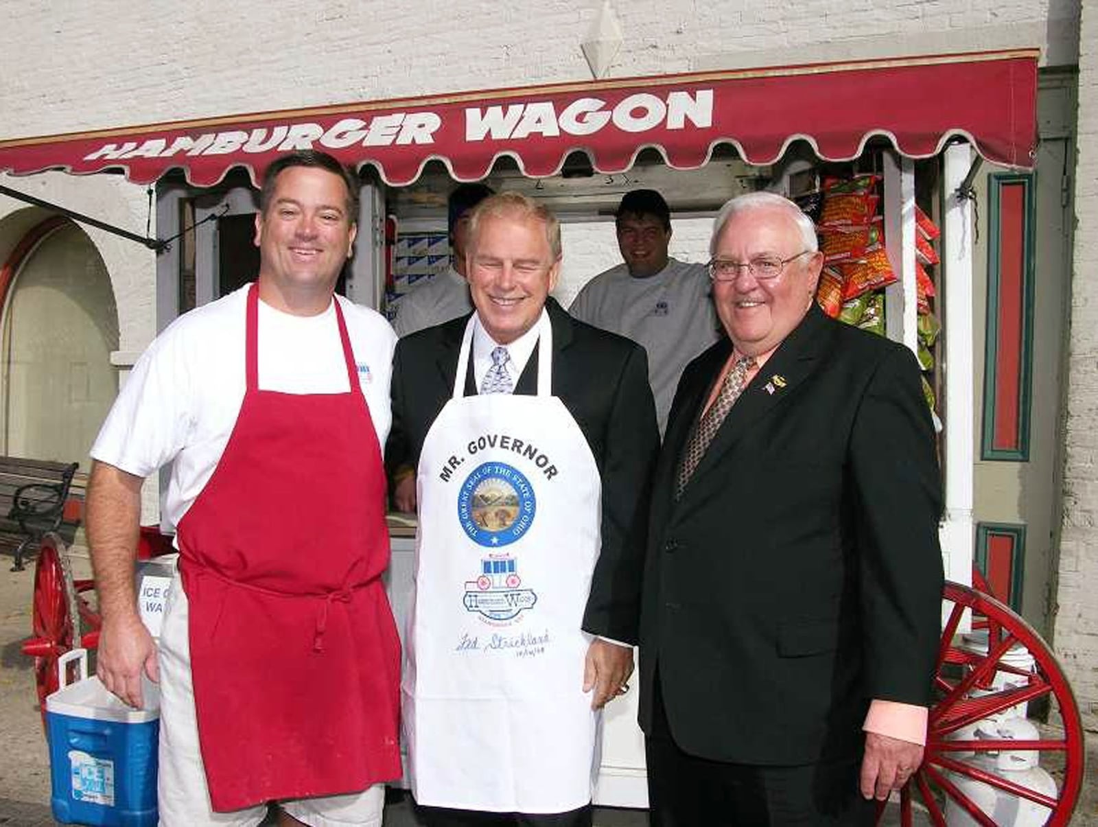 Hamburger Wagon operator Jack Sperry, Ohio Gov. Ted Strickland, and Miamisburg Mayor Dick Church Jr. share a moment in 2008. FILE