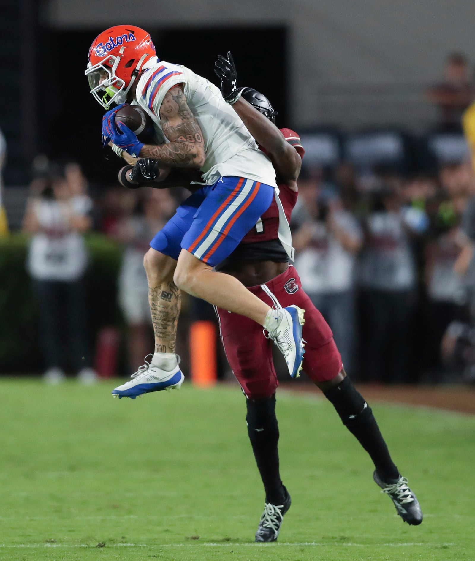 Florida wide receiver Ricky Pearsall (1) makes a catch over South Carolina defensive back Nick Emmanwori (21) during the second half of an NCAA college football game on Saturday, Oct. 14, 2023, in Columbia, S.C. (AP Photo/Artie Walker Jr.)