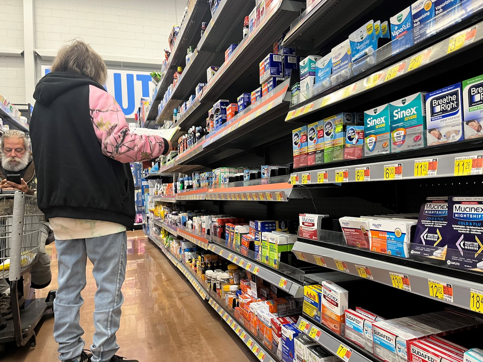 Shoppers at a local store browse the aisles. CORNELIUS FROLIK / STAFF