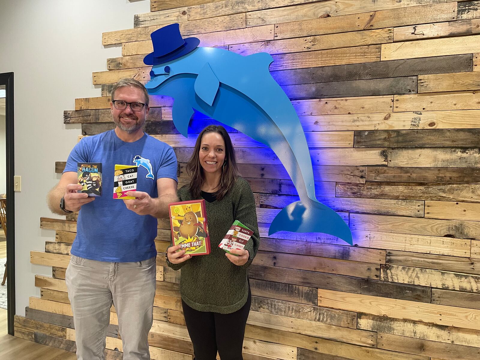 Dolphin Hat Games, a game maker based in Englewood, has been featured on multiple national gift guides this year for its flagship card game, Taco Cat Goat Cheese Pizza. Pictured is founder Dave Campbell and communications director Jenna Schroeder. 