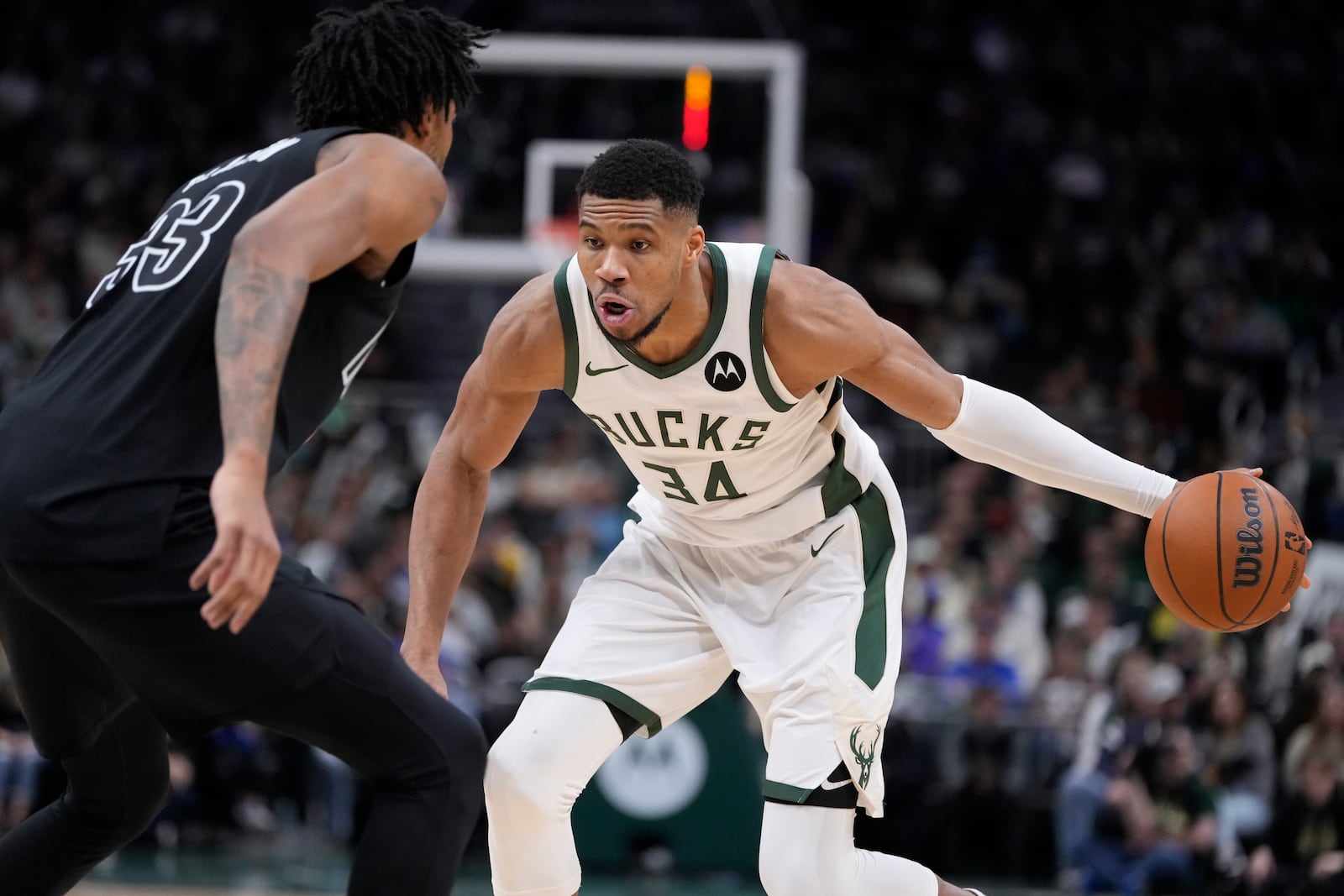 Milwaukee Bucks' Giannis Antetokounmpo tries to get past Brooklyn Nets' Nic Claxton during the second half of an NBA basketball game Thursday, Jan. 2, 2025, in Milwaukee. (AP Photo/Morry Gash)