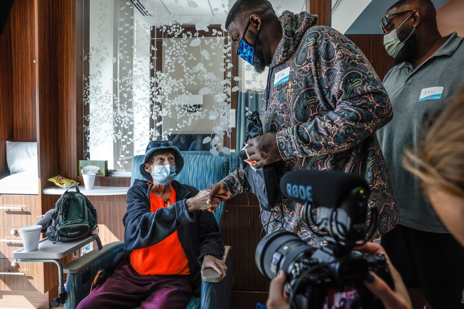 Former Bengals linemen Willie Anderson, center and Levi Jones, right, greet cancer patient Mike Fitzpatrick at the Kettering Health Cancer Center Thursday September 29, 2022. The Bengal legends were at the hospital to deliver care packages, sign banners and visit cancer patients. JIM NOELKER/STAFF