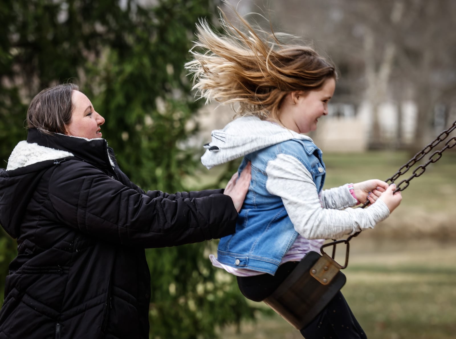 Sara Froats and her daughter, Maggie, 8, play at Rosewood Park in Centerville. Young children across the Miami Valley won't remember a time when COVID wasn't part of our lives. JIM NOELKER/STAFF