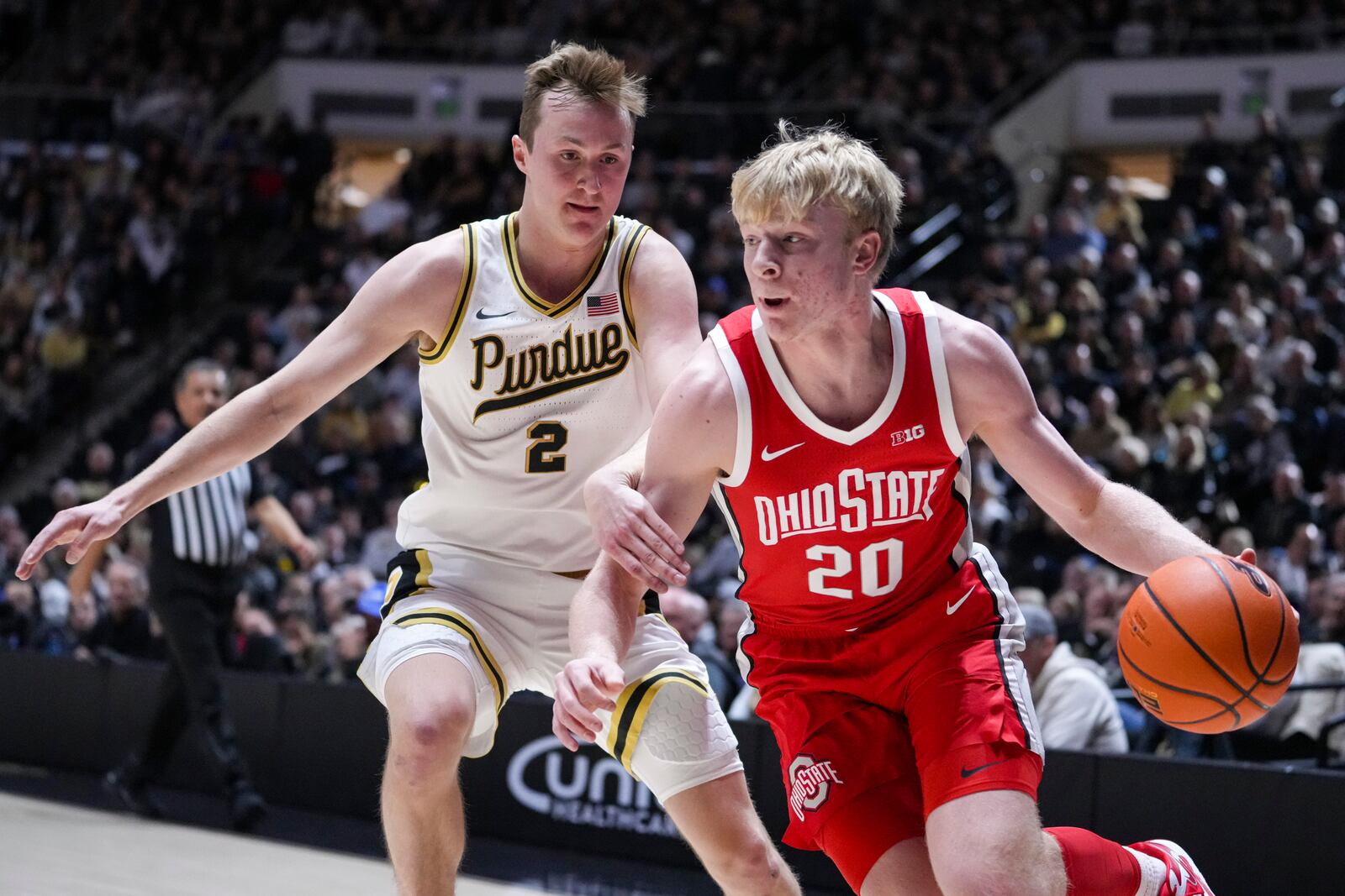 Ohio State forward Colin White (20) drives on Purdue guard Fletcher Loyer (2) during the first half of an NCAA college basketball game in West Lafayette, Ind., Tuesday, Jan. 21, 2025. (AP Photo/Michael Conroy)