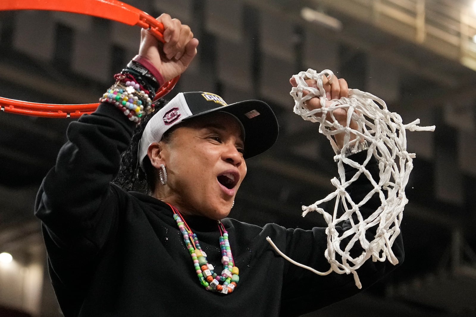 South Carolina head coach Dawn Staley cuts down the net after their win against Texas in an NCAA college basketball game in the final of the Southeastern Conference tournament, Sunday, March 9, 2025, in Greenville, S.C. (AP Photo/Chris Carlson)