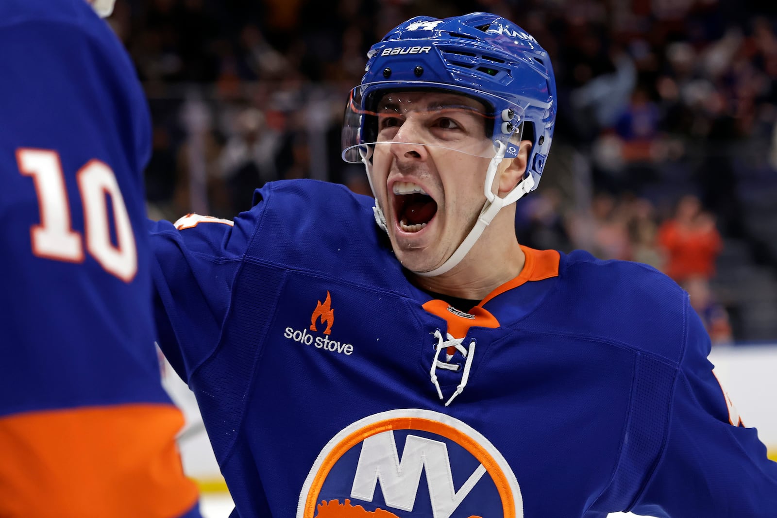 New York Islanders center Jean-Gabriel Pageau reacts after Simon Holmstrom scored a goal in the second period of an NHL hockey game against the Columbus Blue Jackets Monday, Jan. 20, 2025, in Elmont, N.Y. (AP Photo/Adam Hunger)