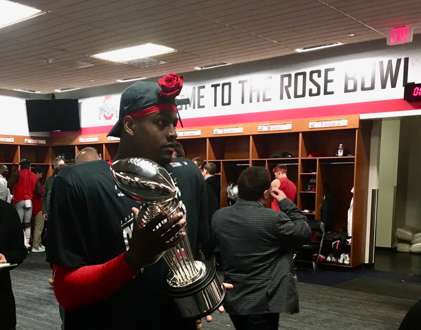 Ohio State tight end Derrick Malone, a graduate of Thurgood Marshall, holds the Rose Bowl trophy in the winning locker room on Jan. 1, 2019, in Pasadena, California.