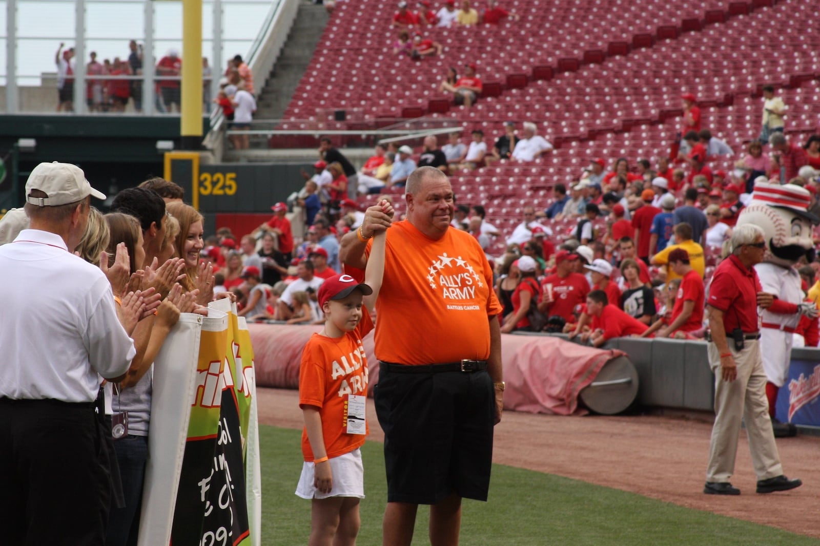 Bob Mills and his granddaugther Ally at Great American Ball Park, where she threw out the first pitch before a game in 2010. CONTRIBUTED