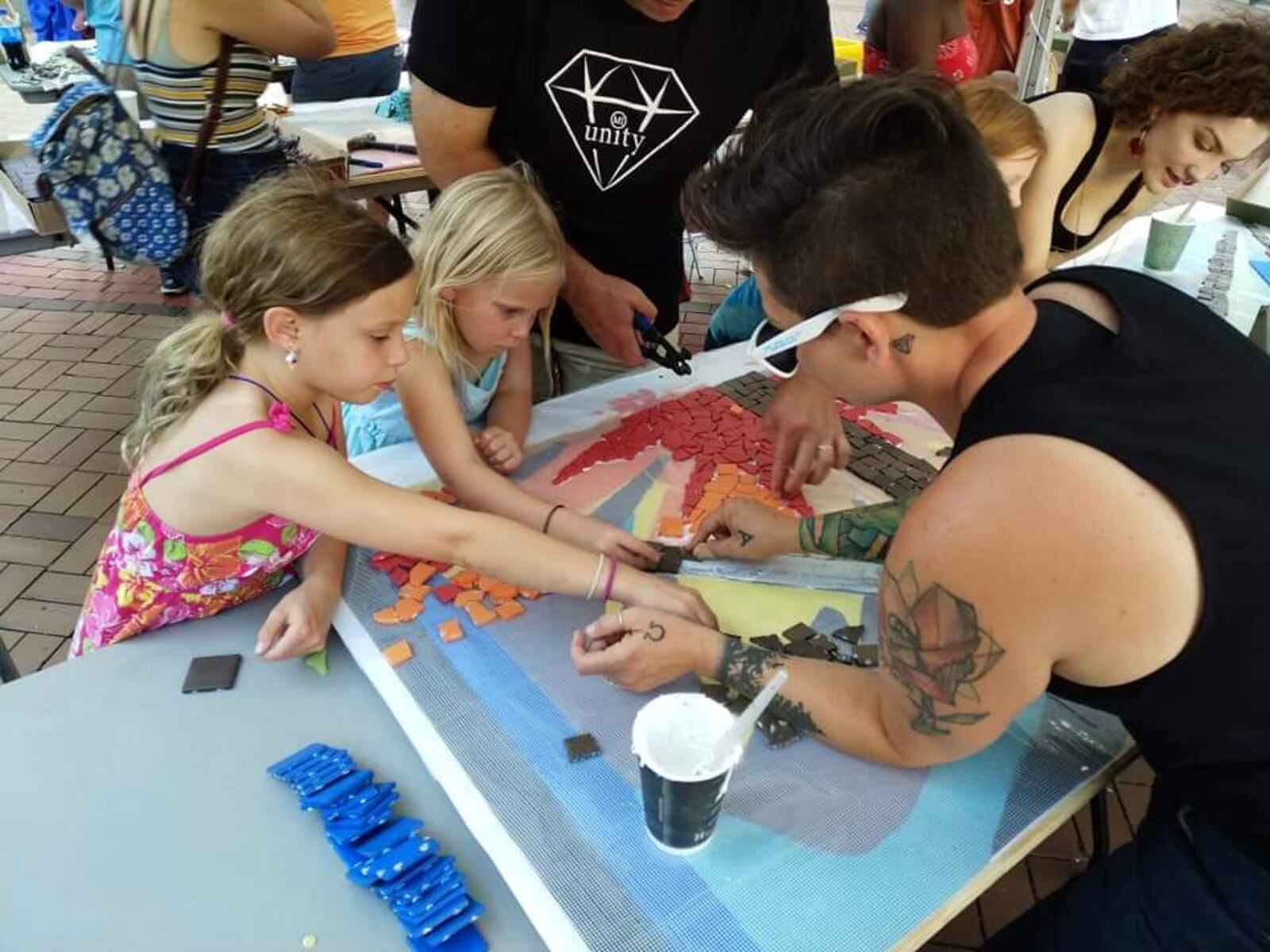 Jes McMillan works with area youth on an art piece. CONTRIBUTED PHOTO