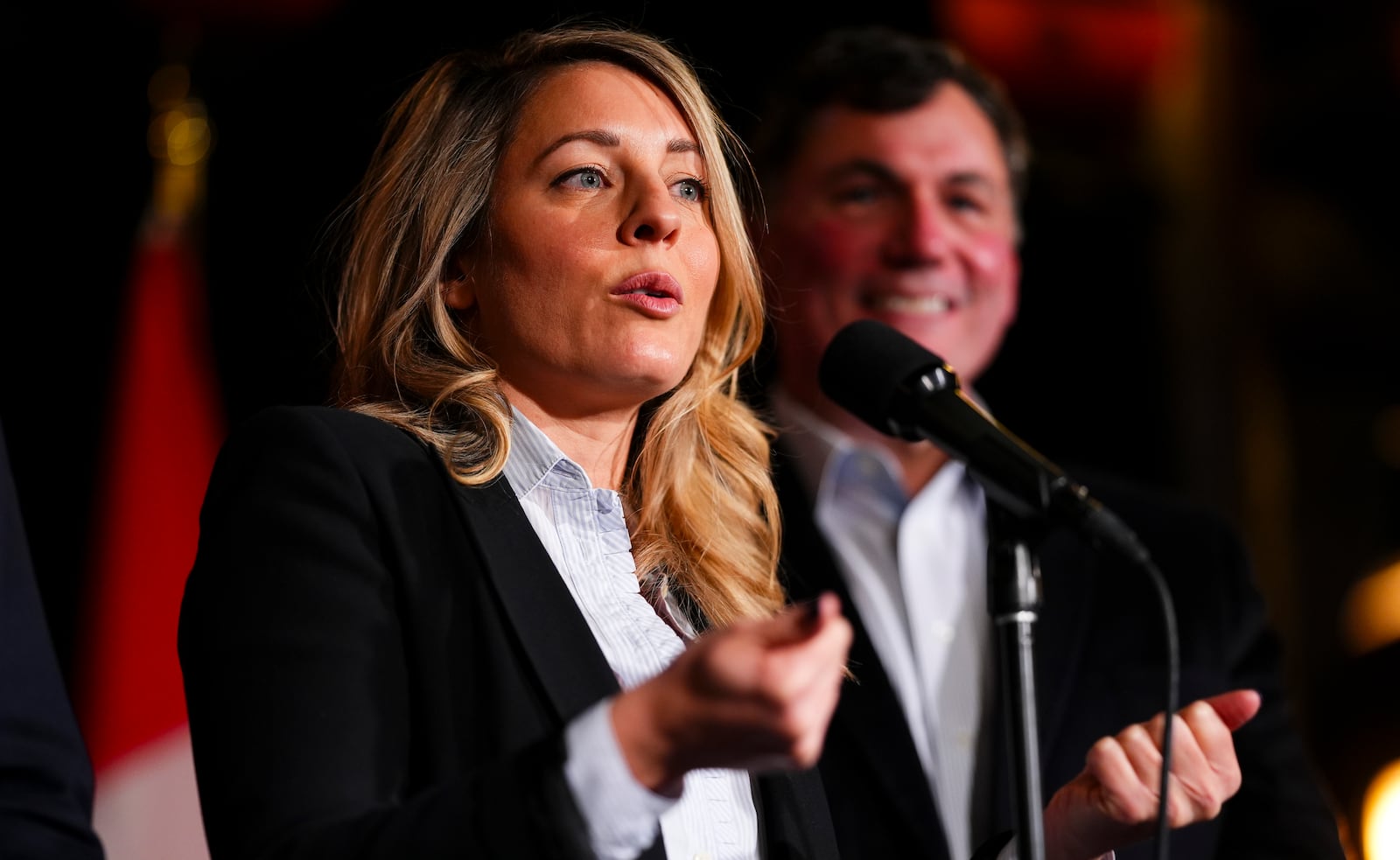 Canada's Minister of Foreign Affairs Melanie Joly and Minister of Finance and Intergovernmental Affairs Dominic LeBlanc speak to reporters prior to a meeting during a cabinet retreat at Chateau Montebello in Montebello, Quebec, Monday, Jan. 20, 2025. (Sean Kilpatrick/The Canadian Press via AP)