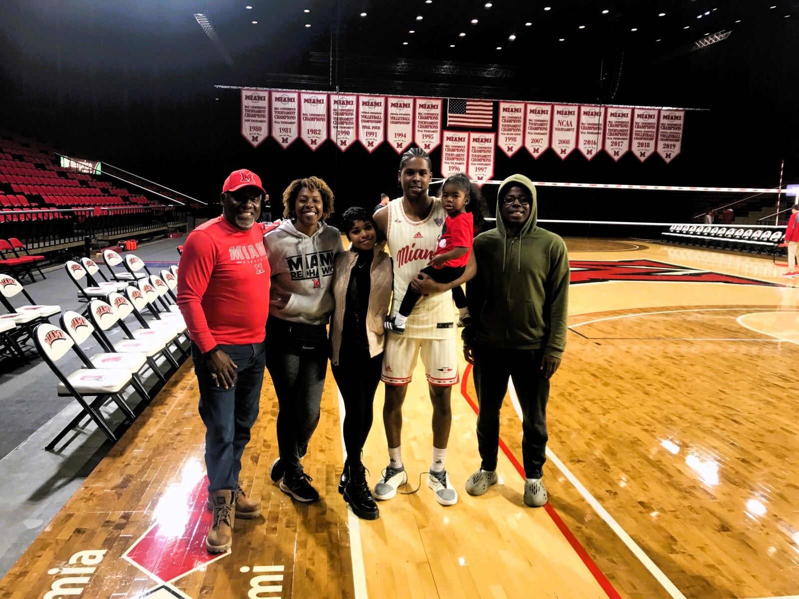 Miami's Darweshi Hunter is pictured with his family after Saturday's game at Millett Hall. Pictured from left, parents Dwayne and Natasha, girlfriend Kilynn Trammell, and their daughter Melah, Darweshi and brother Denzale. Tom Archdeacon/CONTRIBUTED