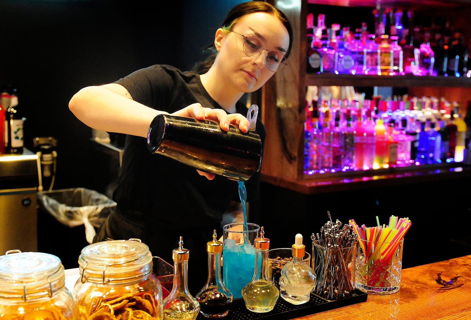 Tatun Pelora, serves up a drink Thursday, Feb. 29, 2024 at Izakaya at the Mall at Fairfield Commons. MARSHALL GORBY\STAFF