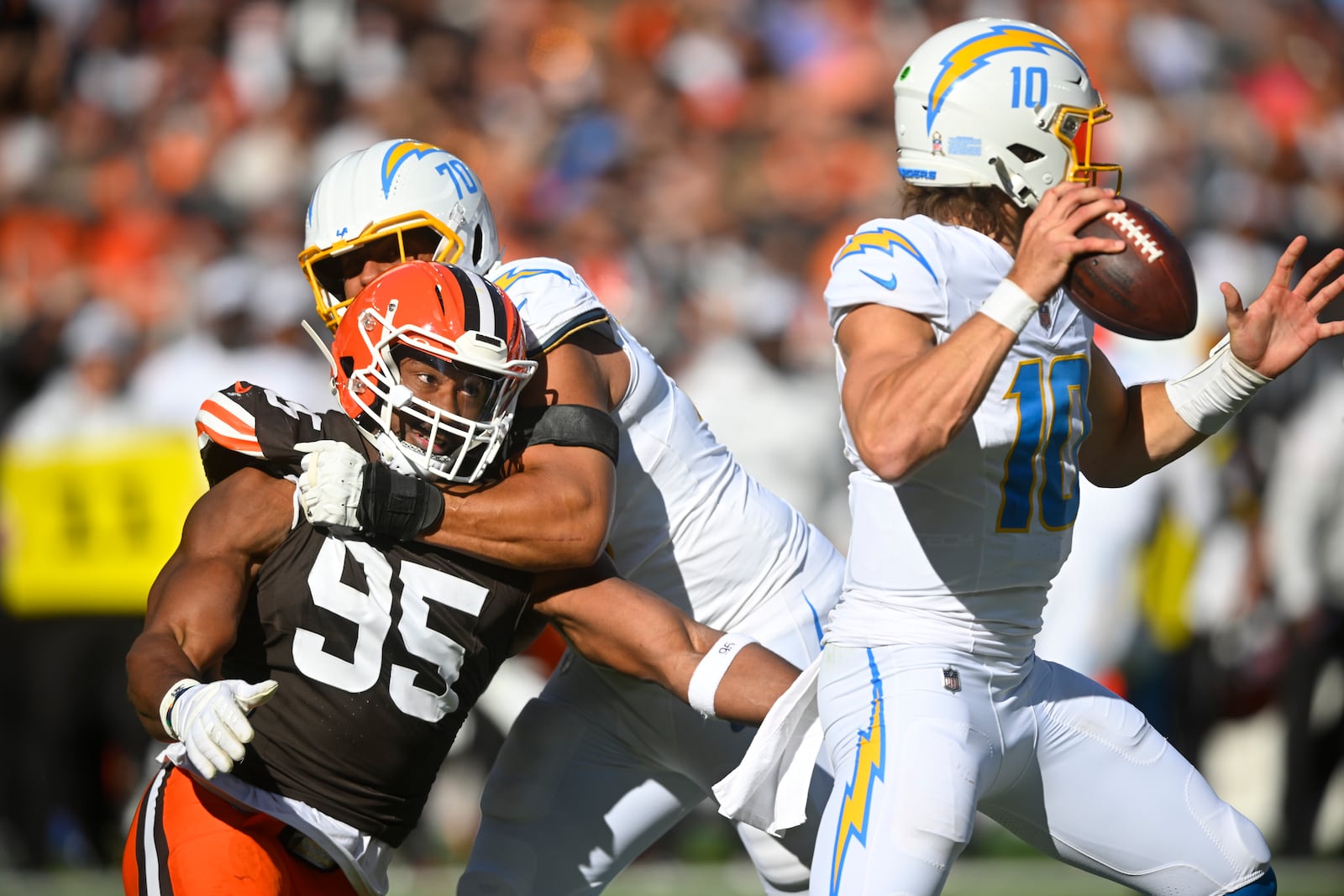 Los Angeles Chargers offensive tackle Rashawn Slater (70) keeps Cleveland Browns defensive end Myles Garrett (95) away from Chargers' quarterback Justin Herbert (10) in the first half of an NFL football game Sunday, Nov. 3, 2024, in Cleveland. (AP Photo/David Richard)