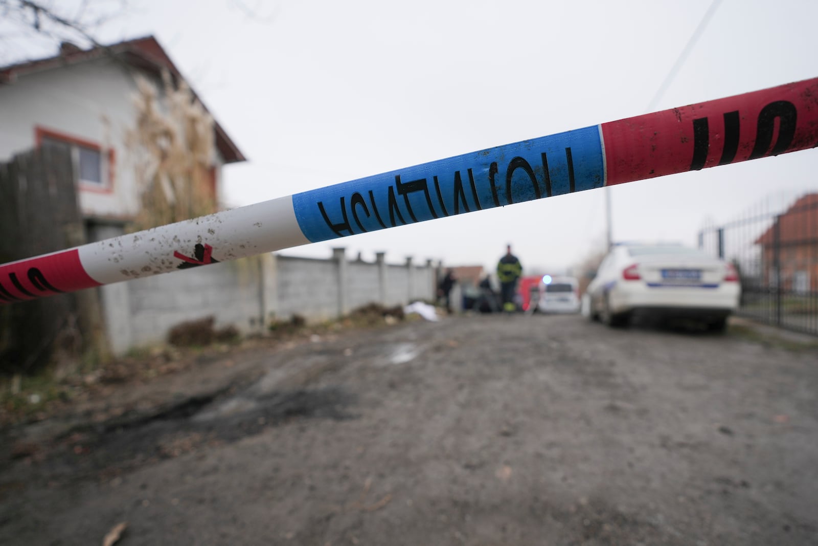 Police guard street in front of a home for the elderly where eight people died in a fire, in Barajevo, a municipality of Belgrade, Serbia, Monday, Jan. 20, 2025. (AP Photo/Darko Vojinovic)