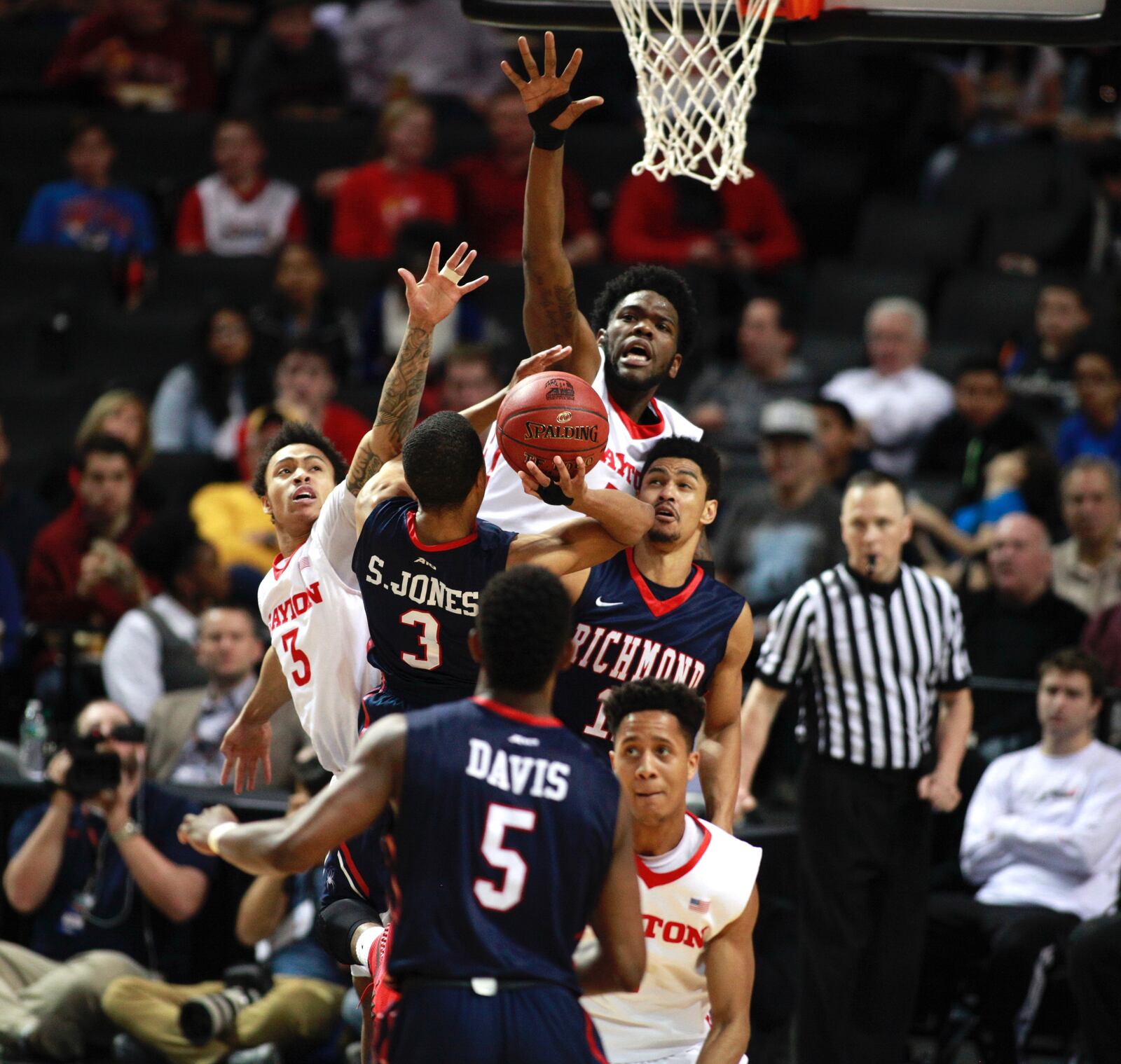 Dayton's Kyle Davis, right and Steve McElvene, back center, try to block a shot by Richmond's ShawnDre' Jones in the quarterfinals of the Atlantic 10 tournament on Friday, March 11, 2016, at the Barclays Center in Brooklyn, N.Y. David Jablonski/Staff