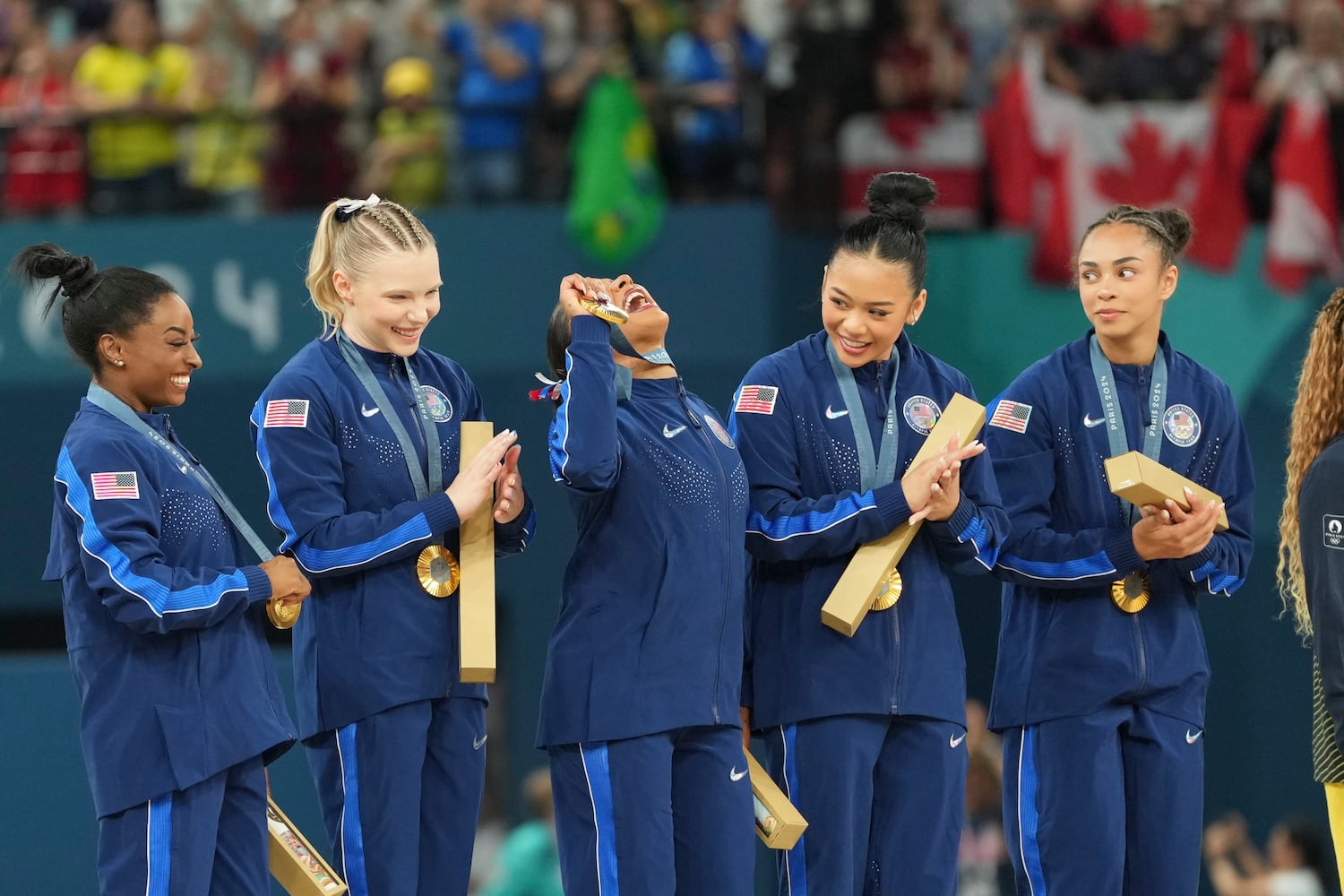 
                        Fom left: Simone Biles, Jade Carey, Jordan Chiles, Sunisa Lee and Hezly Rivera of the U.S. with their gold medals at the medal ceremony in the women's artistic gymnastics team finals at the 2024 Summer Olympics at Bercy Arena in Paris, on Tuesday, July 30, 2024. (Chang W. Lee/The New York Times)
                      