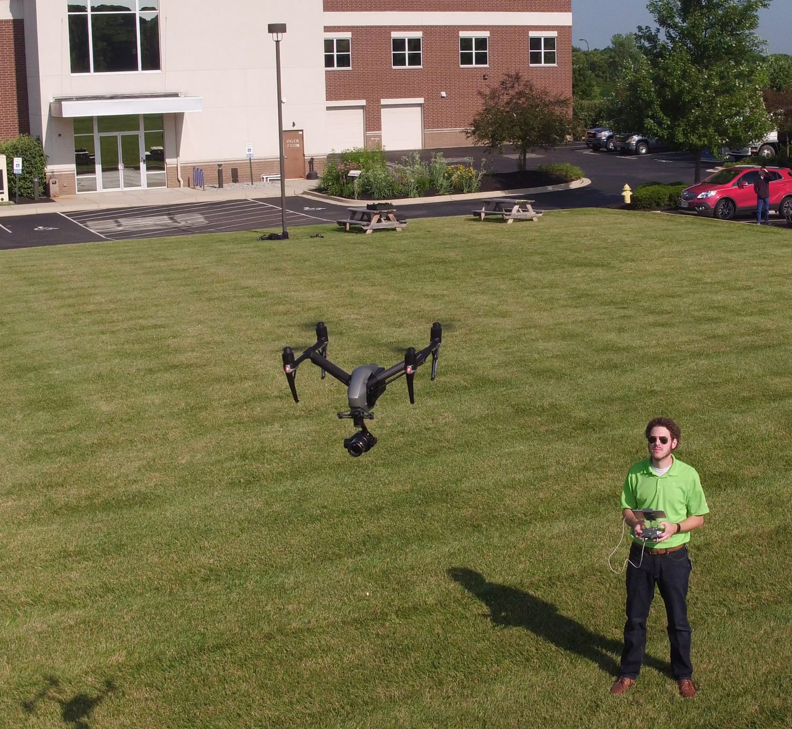 Ethan Schreuder, a survey technician and UAS pilot for Woolpert Architectrure, Engineering and Geospatial, flies one of the many company owned unmanned aerial systems commonly referred to as drones. Using drones for mapping and surveying has become a part of the company’s daily business. TY GREENLEES / STAFF