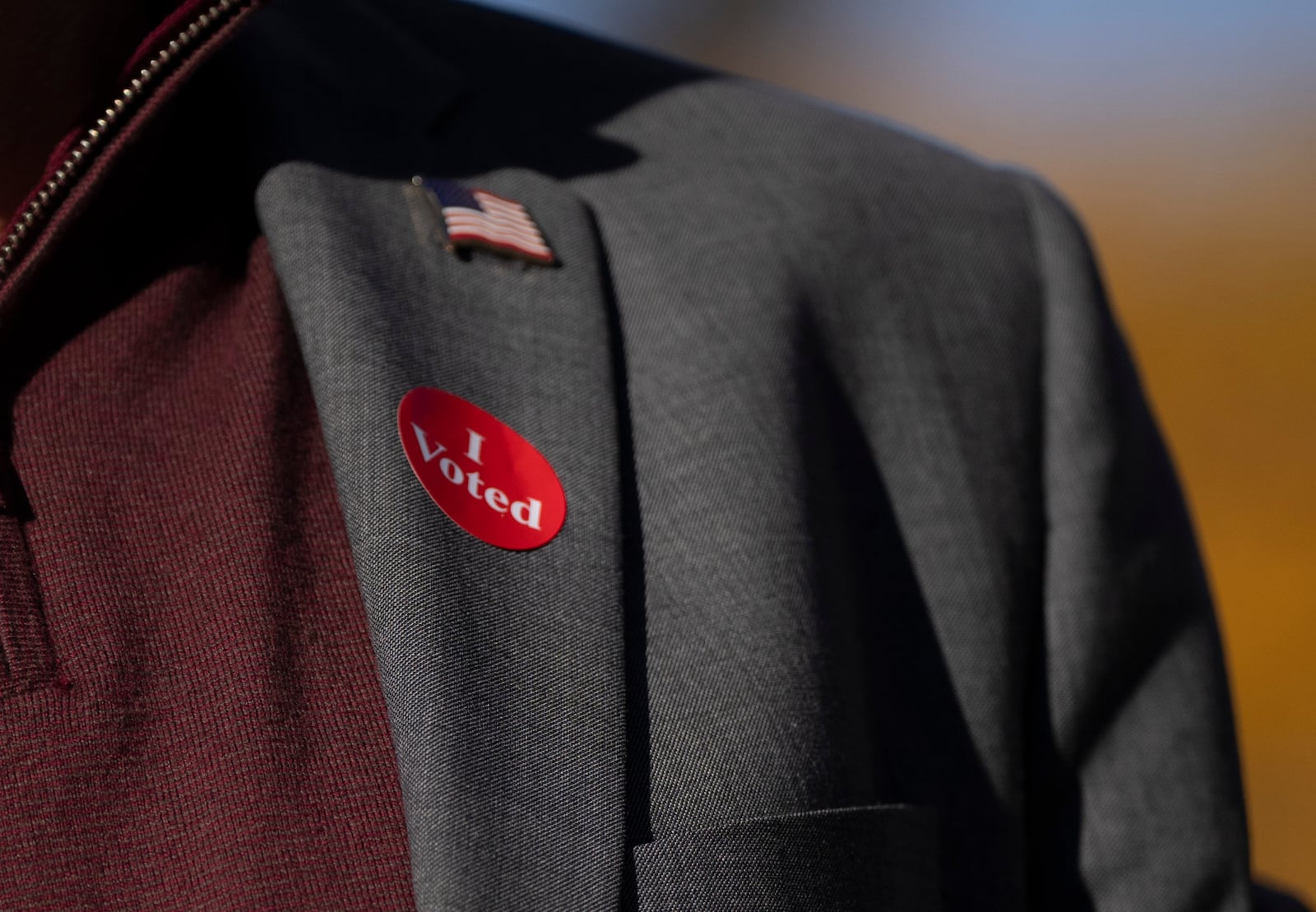 Minnesota Governor and Vice Presidential candidate Tim Walz wears an "I voted sticker" as he speaks to the press after early voting at Ramsey County Elections in St. Paul, Minn., on Wednesday, October 23, 2024. (Renée Jones Schneider/Star Tribune via AP)