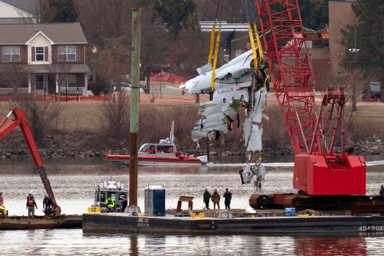 FILE - Rescue and salvage crews with cranes pull up the wreckage of an American Airlines jet in the Potomac River from Ronald Reagan Washington National Airport, Feb. 3, 2025, in Arlington, Va. (AP Photo/Jose Luis Magana, File)