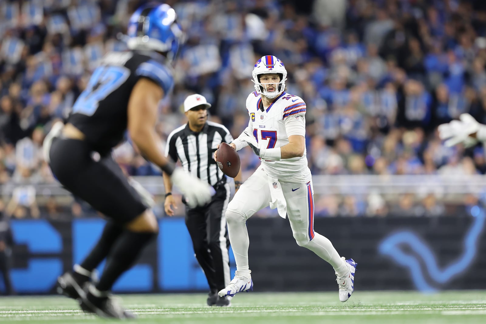 Buffalo Bills quarterback Josh Allen (17) rolls out to pass against the Detroit Lions during the first half of an NFL football game, Sunday, Dec. 15, 2024, in Detroit. (AP Photo/Rey Del Rio)