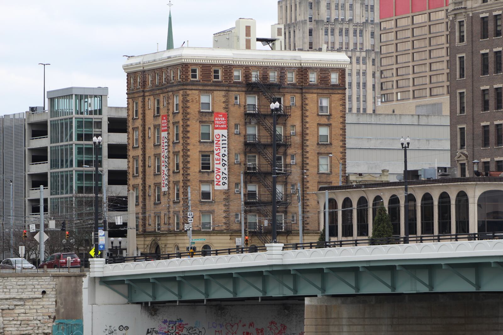 A leasing sign on the side of the Riverfront Grande apartment building in downtown Dayton. CORNELIUS FROLIK / STAFF