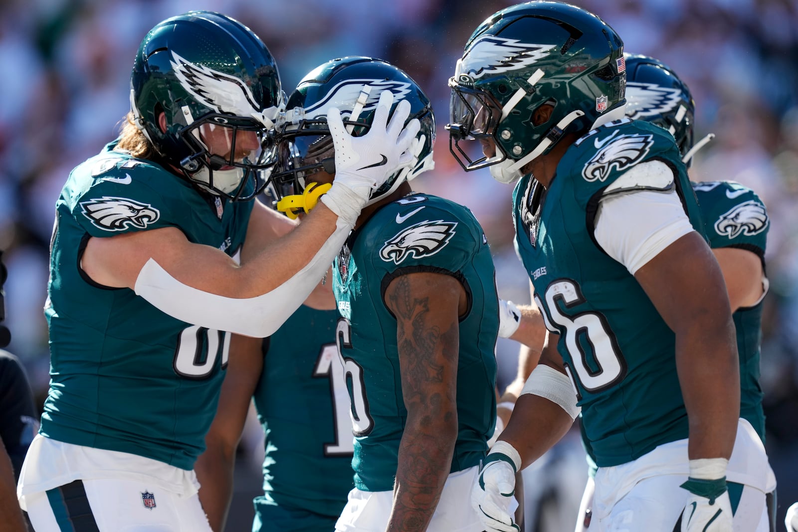 Philadelphia Eagles wide receiver DeVonta Smith, center, celebrates with teammates after catching a long touchdown pass from quarterback Jalen Hurts during the second half of an NFL football game against the Cincinnati Bengals, Sunday, Oct. 27, 2024 in Cincinnati. (AP Photo/Carolyn Kaster)