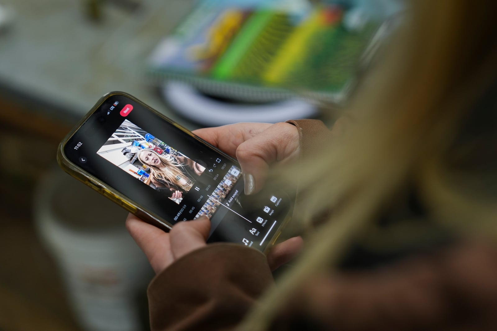 Zoe Kent edits a social media video on the TikTok app, Monday, Jan. 20, 2025, at her farm in Bucyrus, Ohio. (AP Photo/Joshua A. Bickel)