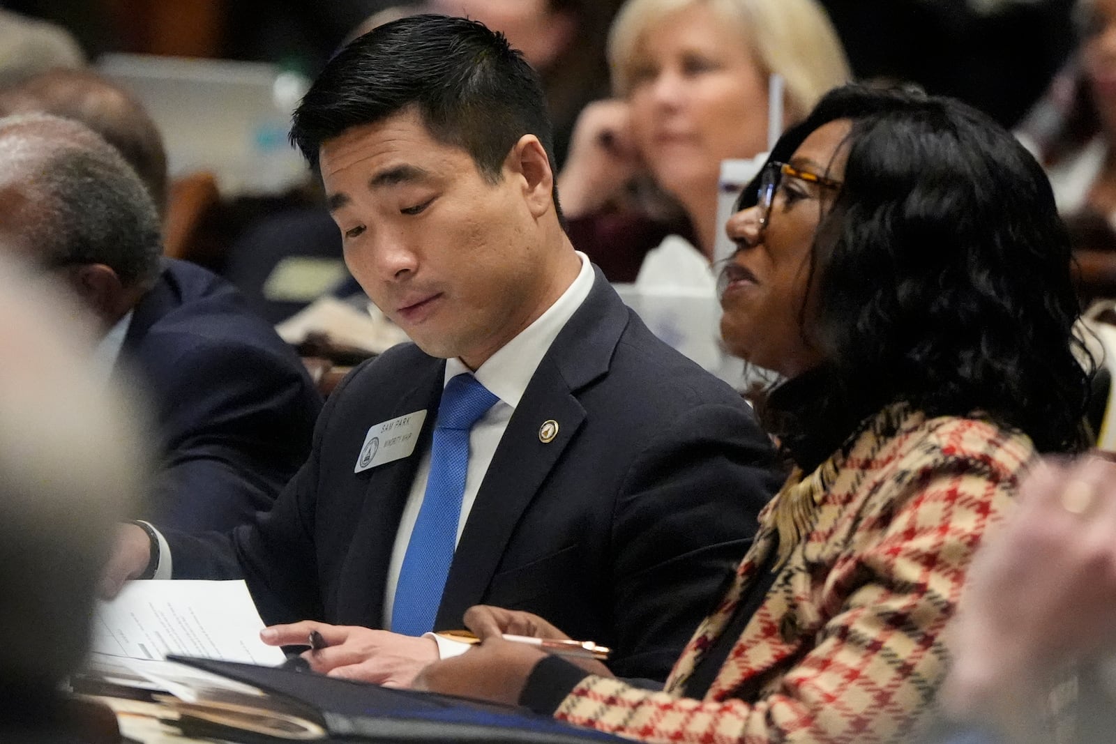 House Minority Whip Sam Park, looks at materials on the House floor, Thursday, March 6, 2025, in Atlanta. (AP Photo/Mike Stewart)