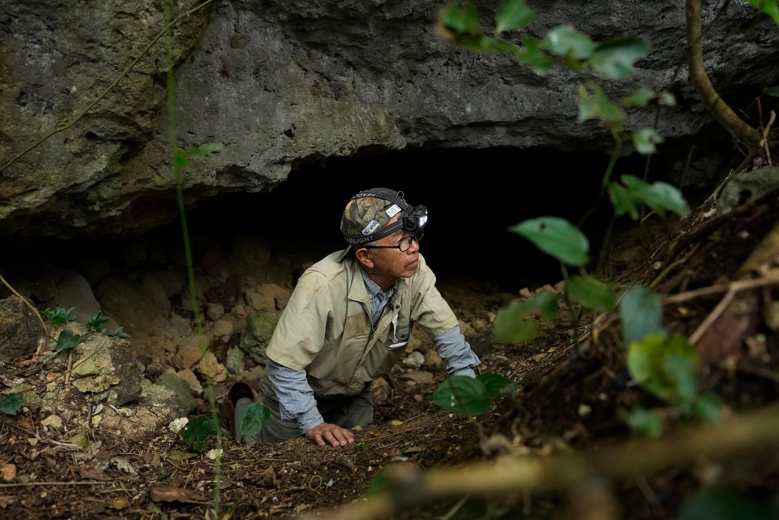 Takamatsu Gushiken leaves a cave after a session of searching for the remains of those who died during the Battle of Okinawa towards the end of the World War II in 1945, in Itoman, on the main island of the Okinawa archipelago, southern Japan, Saturday, Feb. 15, 2025. (AP Photo/Hiro Komae)