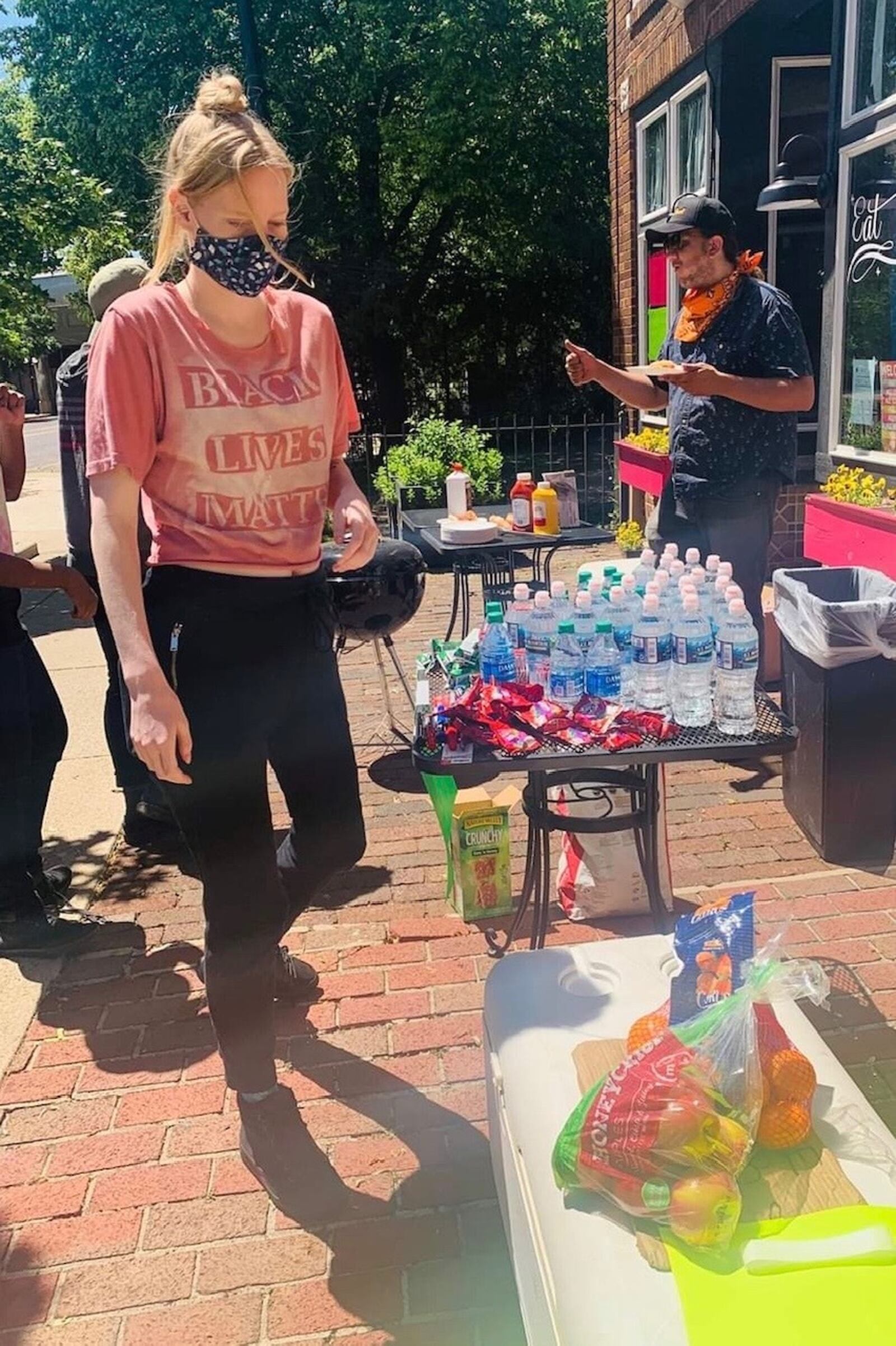 Hannah Williams, assistant manager of Lily's Bistro, sets up food and water for protesters on May 31. CONTRIBUTED PHOTO