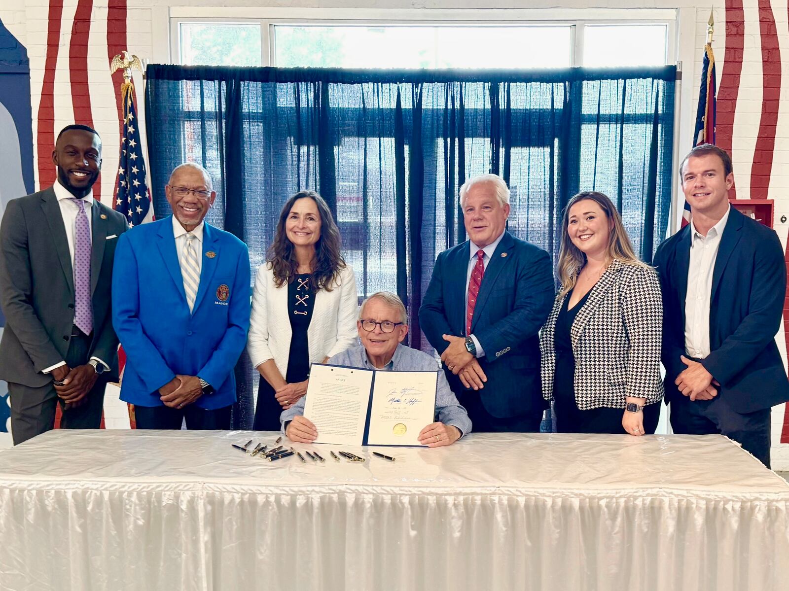 Ohio Gov. Mike DeWine signs an anti-hooning bill that was backed by Dayton Mayor Jeffrey Mims, Jr., along with Dayton-area state legislators Reps. Phil Plummer, R-Butler Twp., and Andrea White, R-Kettering. JULY 24, 2024.