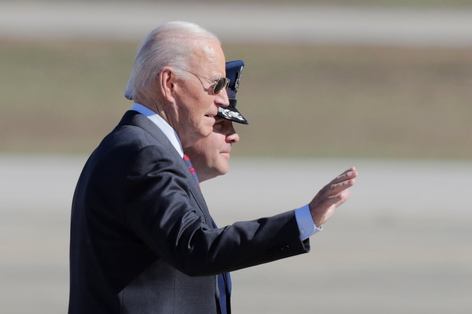 President Joe Biden, left, is escorted by Col. Paul Pawluk, Vice Commander, 89th Airlift Wing, right, as he walks from Marine One before boarding Air Force One at Joint Base Andrews, Md., Tuesday, Oct. 22, 2024. (AP Photo/Luis M. Alvarez)