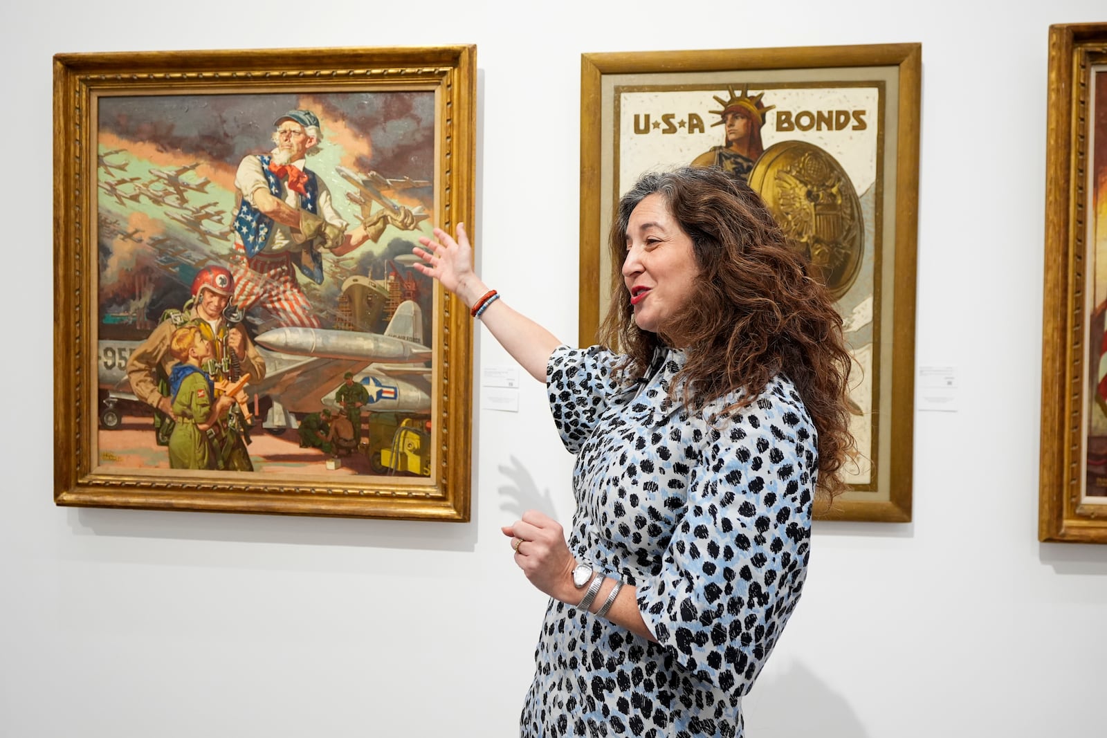 Aviva Lehmann, Heritage Auction's senior vice president of American art, responds to a question as she stands by paintings in Dallas, Thursday, Oct. 17, 2024, that are some of many works from the Boy Scouts of America's art collection — including some paintings by Norman Rockwell — that will go up for auction this month to help compensate tens of thousands of people, mainly men, who were sexually abused while in scouting. (AP Photo/Tony Gutierrez)