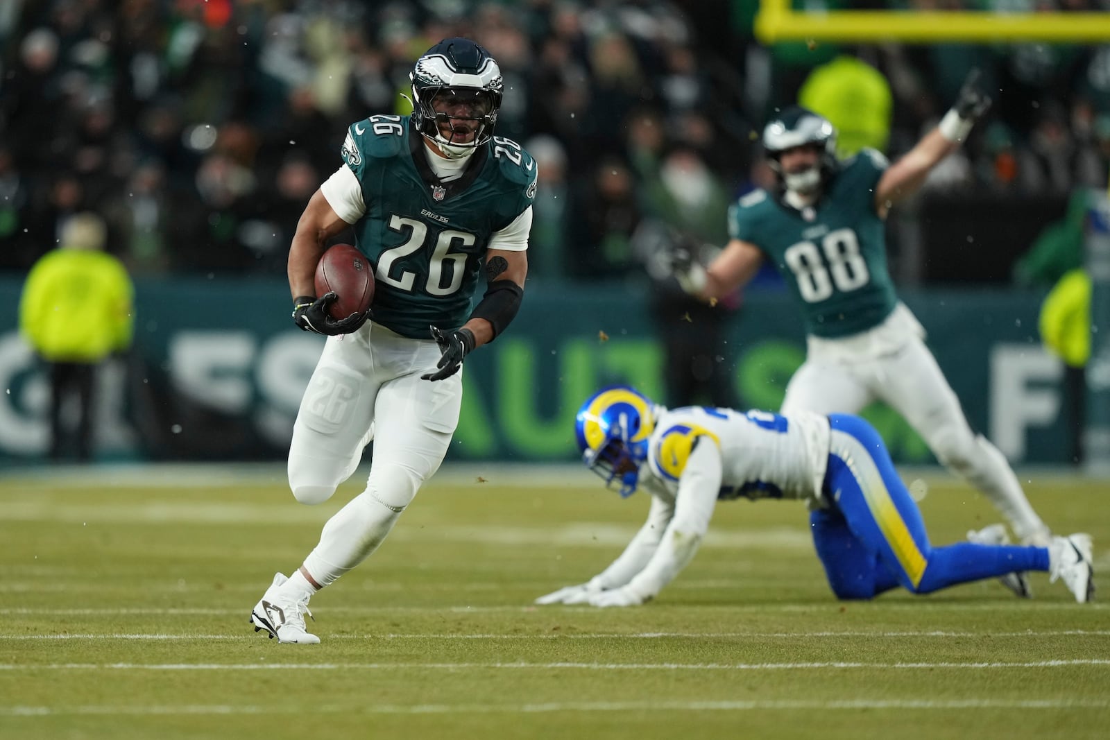 Philadelphia Eagles running back Saquon Barkley (26) runs for a touchdown during the first half of an NFL football NFC divisional playoff game against the Los Angeles Rams on Sunday, Jan. 19, 2025, in Philadelphia. (AP Photo/Matt Slocum)