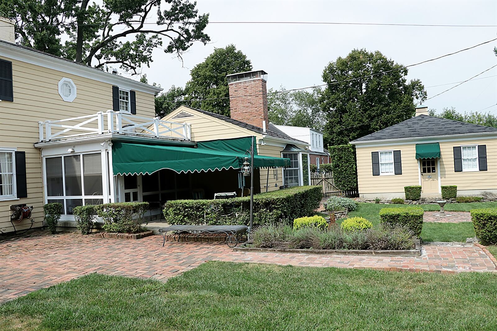 The home sits on a quarter-acre lot with a detached, 2-car garage, covered rear patio and brick garden house with wrap-around porch. CONTRIBUTED PHOTO BY KATHY TYLER