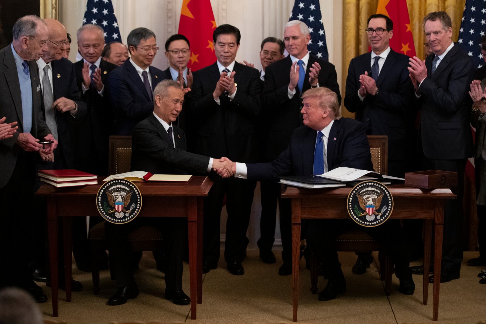 FILE - President Donald Trump and Chinese Vice Premier Liu He shake hands after signing "phase one" of a US China trade agreement, in the East Room of the White House, Jan. 15, 2020, in Washington. (AP Photo/ Evan Vucci, File)