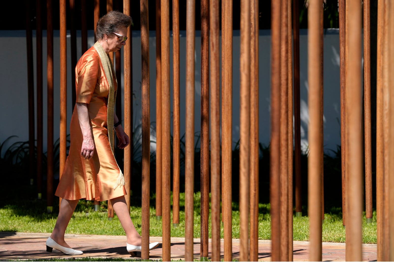 Britain's Princess Anne, the President of the Commonwealth War Graves Commission, walks in between an African "iroko" hardwood post bearing names and the date of death of 1,700 Black South African servicemen who died in non-combatant roles in World War I and have no known grave, in Cape Town, South Africa, Wednesday, Jan. 22, 2025. (AP Photo/Nardus Engelbrecht)