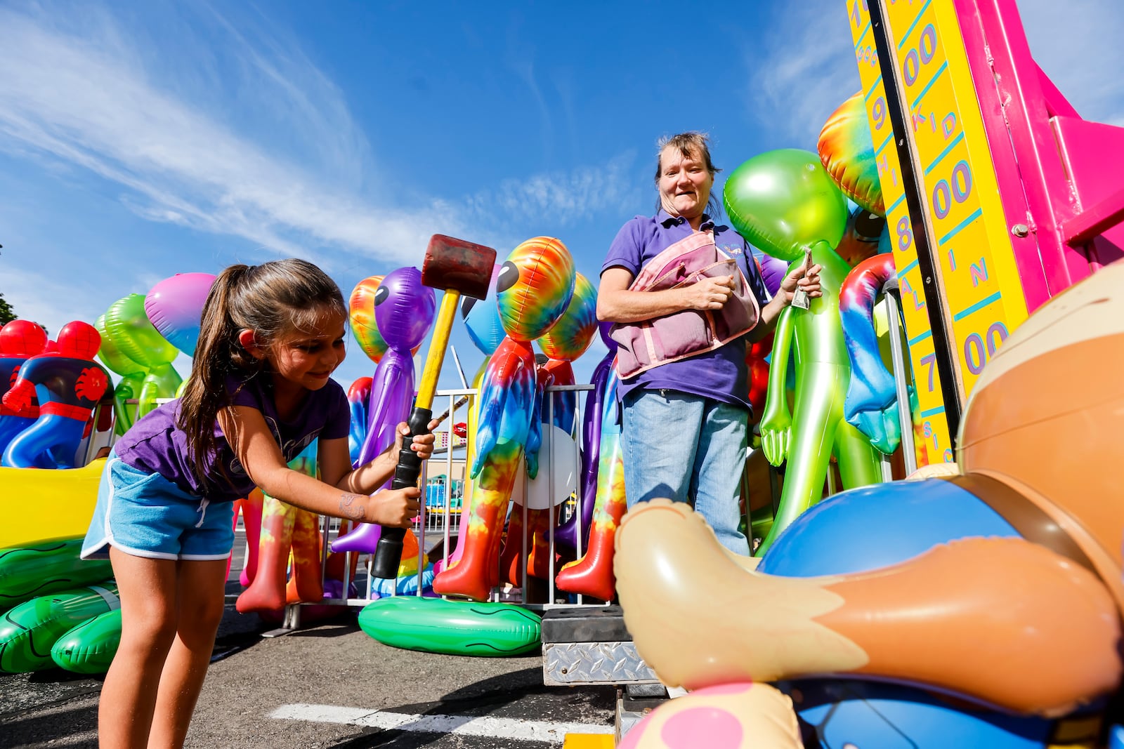 Audrey Saylor-Moore, 5, tries to win a prize at the sledge hammer game as visitors enjoy games, food, rides and more at The Festival at St. John XXIII Friday, June 24 2022 at St. John XXIII school in Middletown. NICK GRAHAM/STAFF