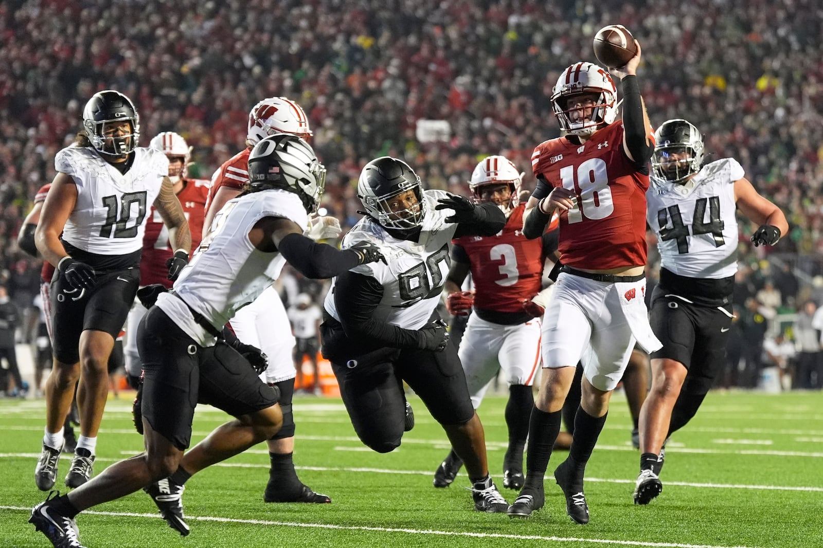 Wisconsin's Braedyn Locke (18) throws a pass during the second half of an NCAA college football game against Oregon Saturday, Nov. 16, 2024, in Madison, Wis. Oregon won 16-13. (AP Photo/Morry Gash)