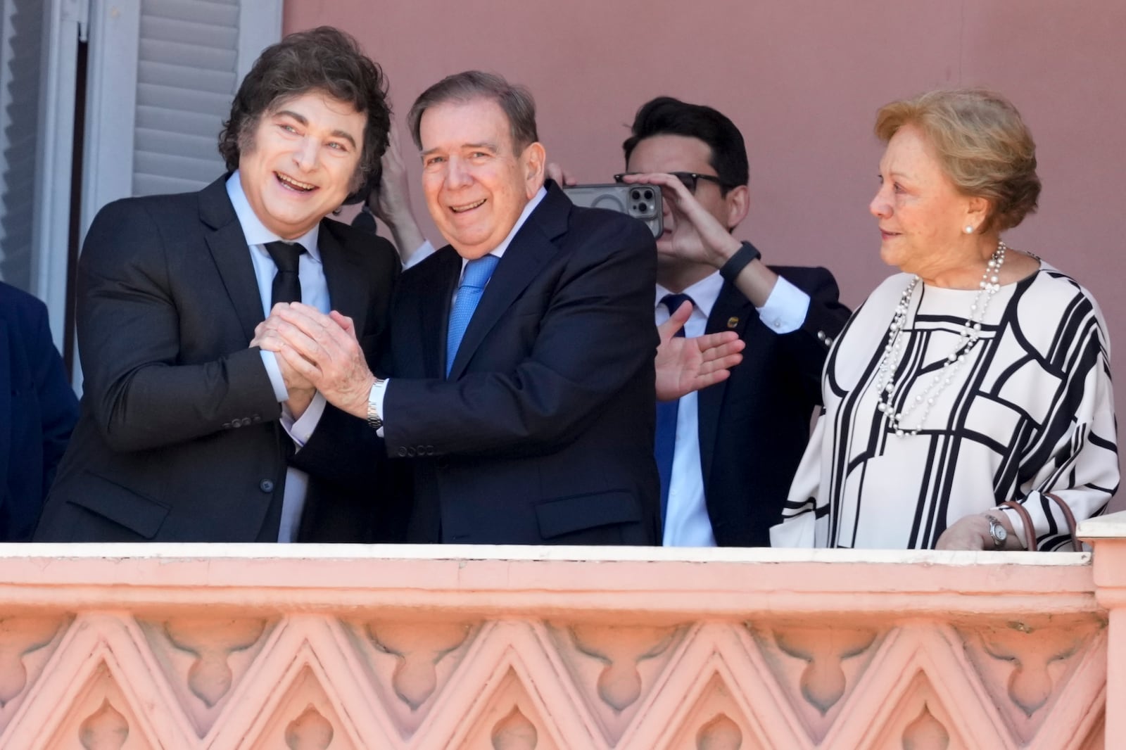 Venezuela's opposition leader Edmundo Gonzalez Urrutia, center, his wife Mercedes Lopez, right, and Argentine President Javier Milei stand at the balcony of the government house in Buenos Aires, Argentina, Saturday, Jan. 4, 2025. Gonzalez, who claims he won the 2024 presidential election and is recognized by some countries as the legitimate president-elect, traveled from exile in Madrid to Argentina. (AP Photo/Natacha Pisarenko)