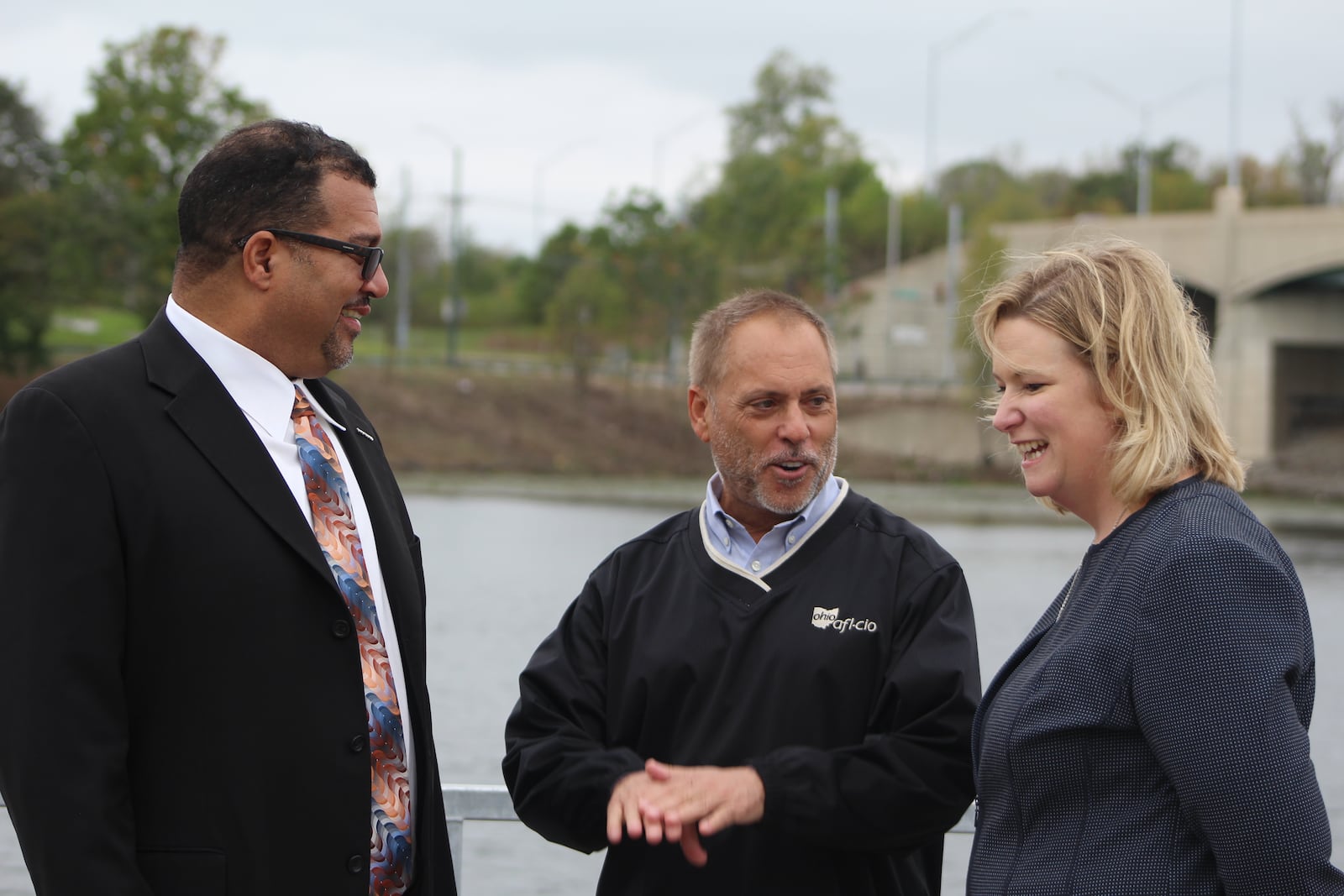 Dayton City Commissioner Chris Shaw, Ohio AFL-CIO President Tim Burga and Dayton Mayor Nan Whaley stand on the new fishing pier on Lakeside Lake.