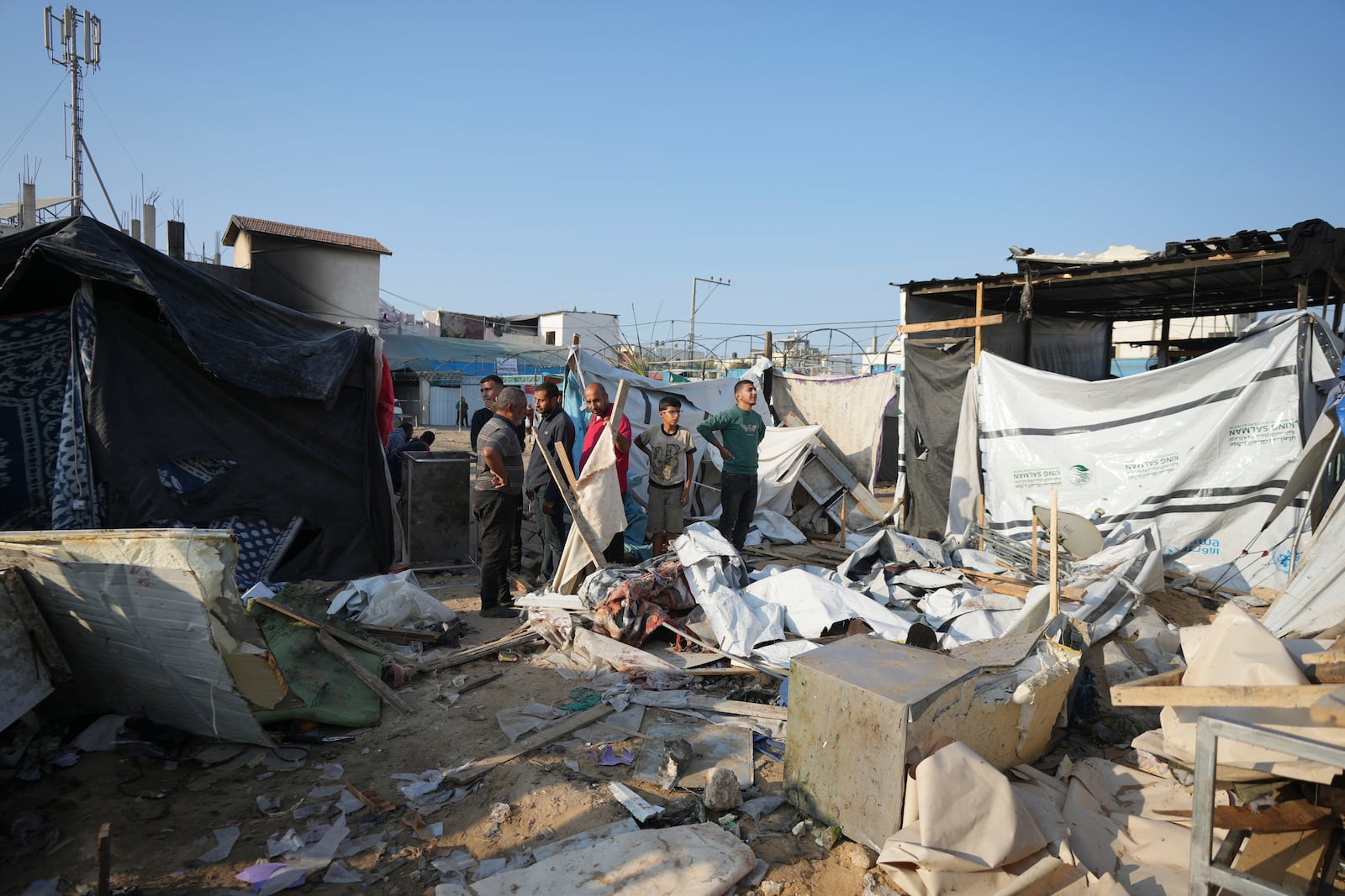 Palestinians gather at the site of an Israeli strike in the courtyard of the Al-Aqsa Hospital where displaced people live in tents, in Deir al-Balah, Gaza Strip, Saturday, Nov. 9, 2024. (AP Photo/Abdel Kareem Hana)