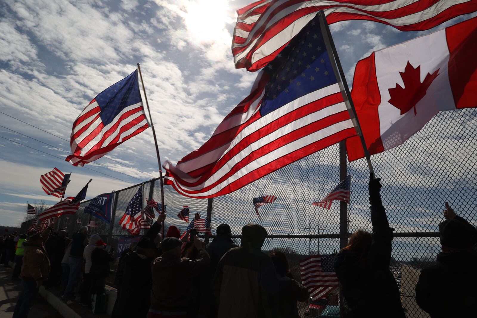 People gather on Clark County overpasses to show support for The People's Convoy traveling eastbound on I-70 Thursday. BILLLACKEY/STAFF