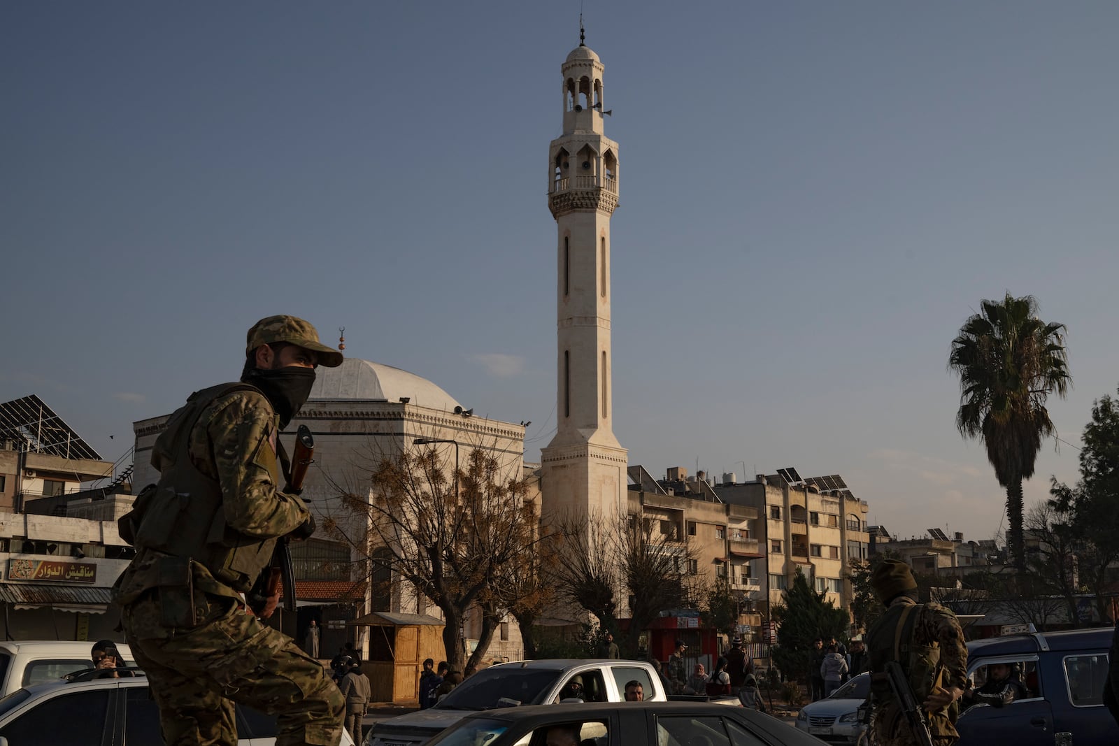 A member of the security forces of the newly formed Syrian government patrols an area near to a security checkpoint in Homs, Syria, Thursday, Dec. 26, 2024. (AP Photo/Leo Correa)